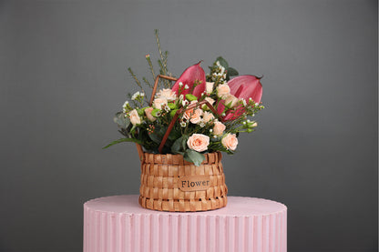 Basket of antrim, baby rose, wax flower, and eucalyptus