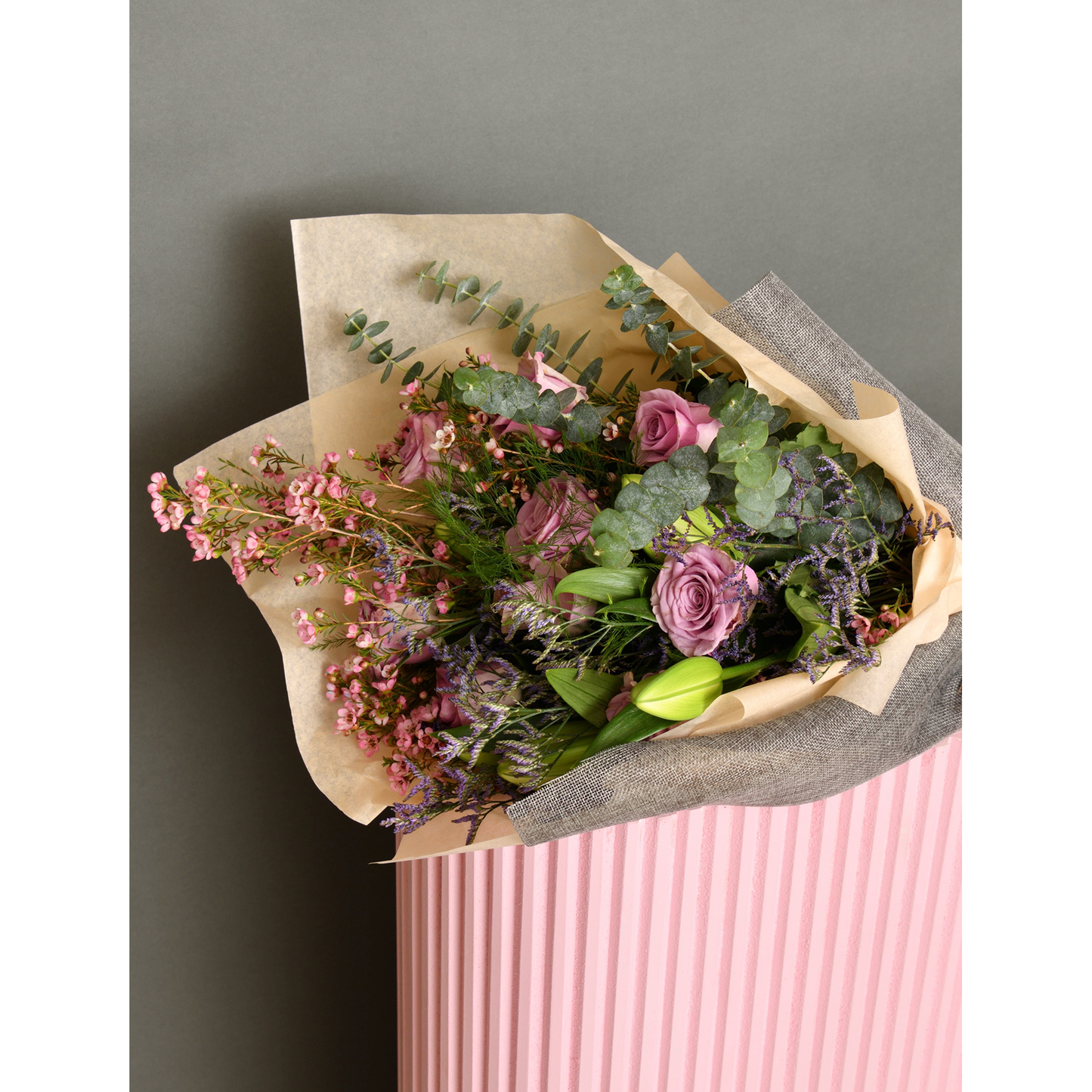 Bouquet of roses, wax flowers, lilium and limonium, eucalyptus