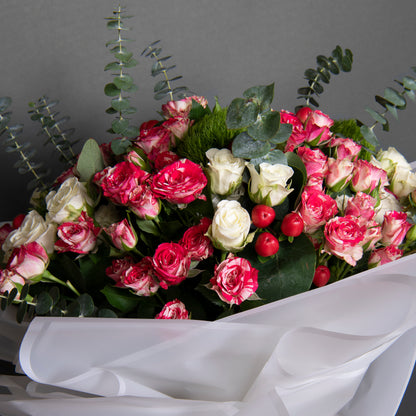 Large, bright bouquet with rose, hypericum, eucalyptus